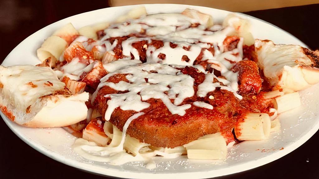 Grilled Chicken Parm · 2 Pieces of Char Broiled Chicken over a bed of Pasta covered in Homemade Sauce with melted Mozzarella and Parmesan cheese. 2 Homemade Meatballs and our famous Garlic Bread