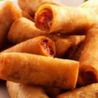 Lumpiang Shanghai · Mini pork egg rolls with sweet chili dipping sauce.