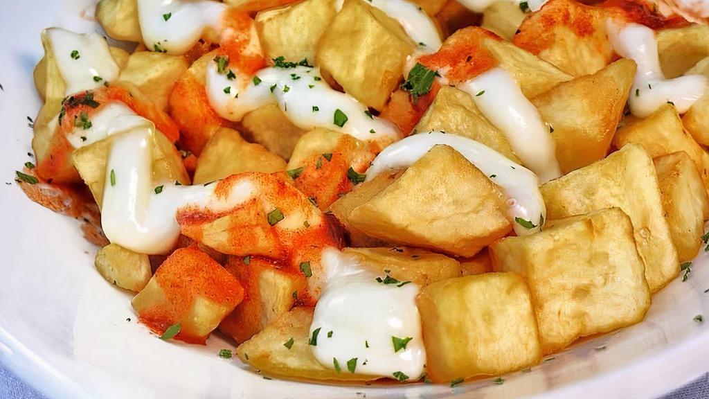 Patatas Bravas · Fried cubed potatoes with spicy Brava and ali-oli sauce. Vegetarian and gluten free.