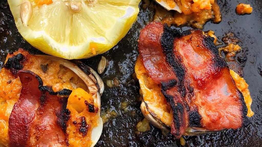 Almejas Rellenas · Baked stuffed clams topped with bacon.