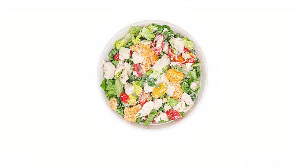 Kale Caesar Salad · Kale, romaine, cherry tomato, Parmesan, Parmesan crisps, chicken, Caesar dressing and lime squeeze.