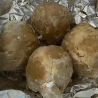 Zeppolis · 4 Italian fried dough balls with powdered sugar.