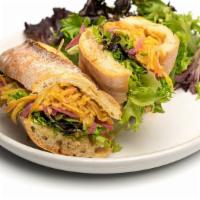 Apple Baguette (Vegetarian) · Julienned fuji apples sautéed with maple syrup and brie, baby greens and pickled red onions ...
