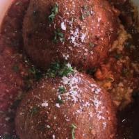 Rice Balls · Seasoned rice stuffed with ground beef, peas, and mozzarella served over our homemade meat s...