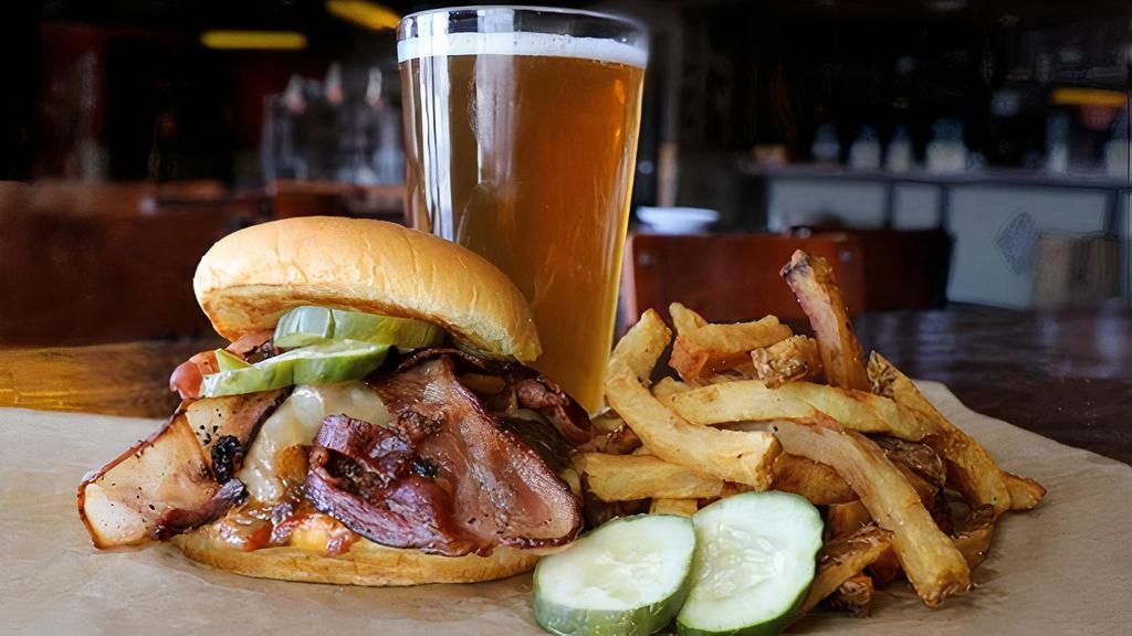 Bacon Deluxe Burger · Certified Angus Beef ®, BBQ basted, caramelized tangy onions, thick-cut bacon, melted Swiss, pickles.
