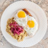Tres Golpes · Favorite. Two eggs, any style, two fried salami, two fried cheese and mangu encebollado with...