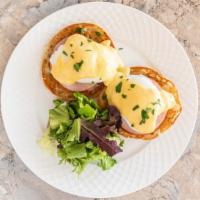 Classic Eggs Benedict · Two poached eggs and Canadian bacon or pork bacon on an English muffin topped with hollandai...