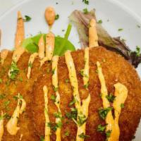 Crab Cakes · Served on a bed of greens and heat spicy aioli.