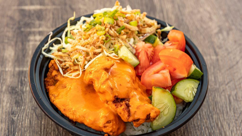 Spicy Chicken Bowl · Rice bowl with spicy garlic chicken, tomato, cucumber, sesame citrus slaw, and crispy onions