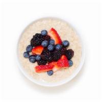 Berry Oatmeal Bowl · Warm rolled oats made with almond milk and topped with blueberries, strawberries, and almonds.