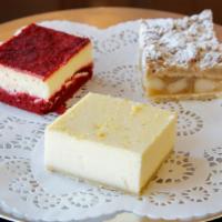 Red Velvet Cheesecake Square · Our classic Hungarian cheesecake with a red velvet cake base and topped with red velvet crum...