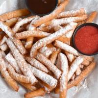 Funnel Cake Fries · A boardwalk favorite with a turtle twist! Funnel cake fries covered in powdered sugar. Serve...