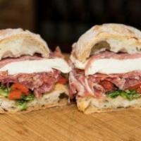 Godfather Panini · Three meats, peppers, greens, and mozzarella. Served with extra virgin olive oil and crema d...
