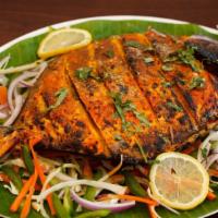 Tandoori Pomfret (Whole Fish) · Whole Pomfret cooked in tandoor brick oven.