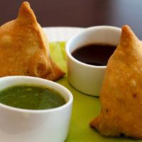 Samosa Veg · Three pieces of curried potatoes pastry.