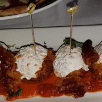 Arancini · Rice balls, over tomato sauce with fresh mozzarella and crispy prosciutto.