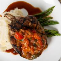 Reserve Center Cut Pork Chop · Double cut, bone-in grilled pork chop, agro-dolce peppers &  onions, served over roasted gar...