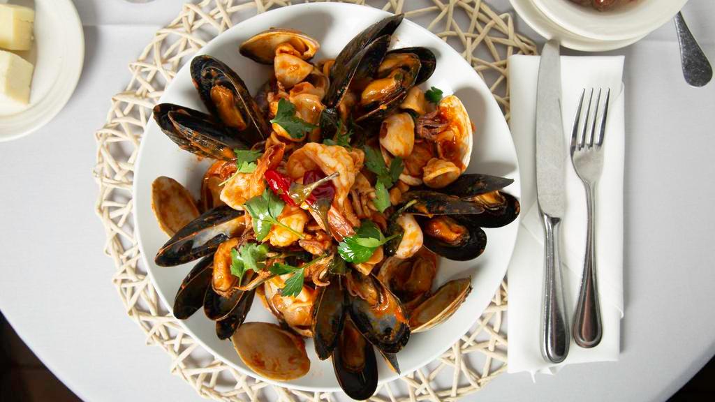 Linguine Seafood · Shrimp, mussels, clams and calamari in a garlic white wine tomato sauce.topped with spicy Calabrian chili