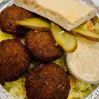 Falafel Platter · Our homemade fresh falafel balls served on a bed of salad, sauerkraut, pickles, tahini, hari...
