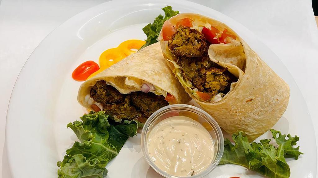 Falafel Wrap · Falafel & Israeli Salad wrapped in a fresh flour tortilla, with tahini dressing on the side
