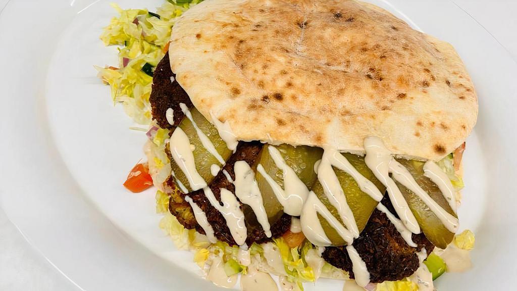Whole Falafel · Whole Falafel Served with chopped salad, our homemade falafel balls, bakery fresh pita, sauerkraut, pickles.  Tahini & Harif on the side