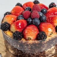 Cheese Cake · A rich, delicious cake covered in berries, chocolate cake crumb wall, and a wonderfully unct...