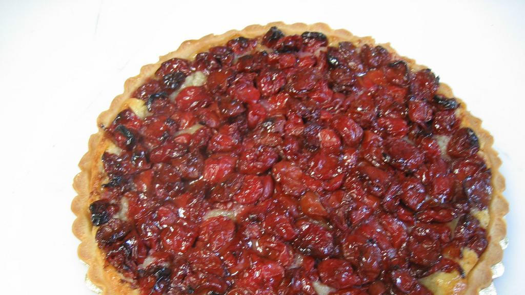 Sour Cherry Tart · Sour cherries, famous in Europe for their deliciously spicy flavor, contrast with a slightly sweet frangipane base, nestled inside our rich butter pastry.