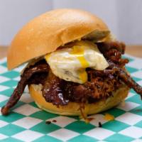 The Mother Load · Slow smoked pulled pork topped with thin sliced marinated flank steak and an egg cooked medi...