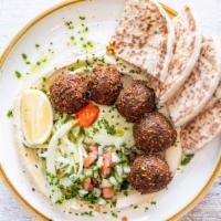 Falafel Bowl Over Hummus · Pickled cabbage, sour pickles, smashed avocado + tahini w/ a side of pita.