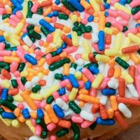Happy Vanilla Frosted · Glazed donought topped with vanilla frosting and covered in rainbow sprinkles.