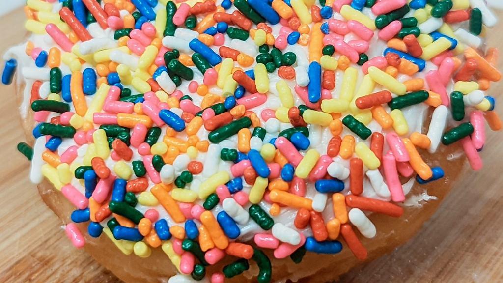 Happy Vanilla Frosted · Glazed donought topped with vanilla frosting and covered in rainbow sprinkles.