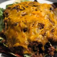 Ridge Nachos · Tortilla chips, lettuce, tomatoes, black olives, jalapeños, chili, and melted cheddar cheese...
