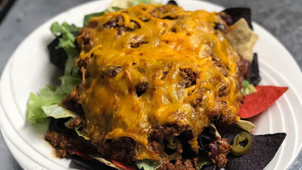 Ridge Nachos · Tortilla chips, lettuce, tomatoes, black olives, jalapeños, chili, and melted cheddar cheese. Served with salsa, sour cream, and guacamole.