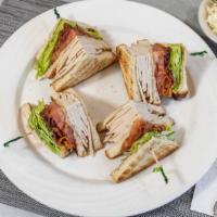Roast Turkey Club · With bacon, lettuce, tomato, and mayonnaise. Served on three slices of toast with coleslaw a...