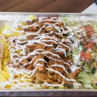 Chicken Shawarma Platter · Includes yellow rice, pita bread, & signature garlic sauce. Topped with crispy lettuce, cucu...