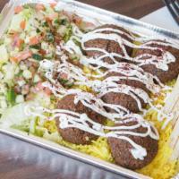 Falafel Platter · Includes yellow rice, pita bread, & signature garlic sauce. Topped with crispy lettuce, cucu...