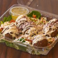 Falafel Salad · Flavorful, fresh greens that include: baby spinach, Romaine lettuce, tossed with our famous ...
