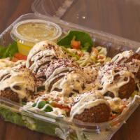 Falafel Salad (Vegan) · Flavorful, fresh greens that include: baby spinach, Romaine lettuce, tossed with our famous ...