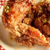 Chili Garlic Chicken Wings · Overnight marinated wings fried and tossed in spicy red chili vinaigrette and crusted peanuts.