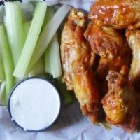 Spicy Buffalo Chicken Wings · Served with bleu cheese dressing and celery sticks.