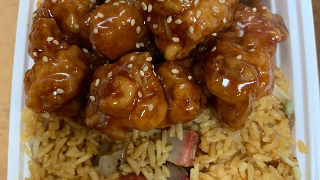 Sesame Chicken · Dark chicken meat specially prepared and blended with a mouth watering brown sauce and covered sesame seeds. served with white rice.