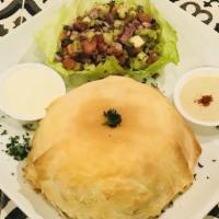 Ouzi · A special pie made up of rice, peas, carrots, raisins and flavored with almonds. Served with...