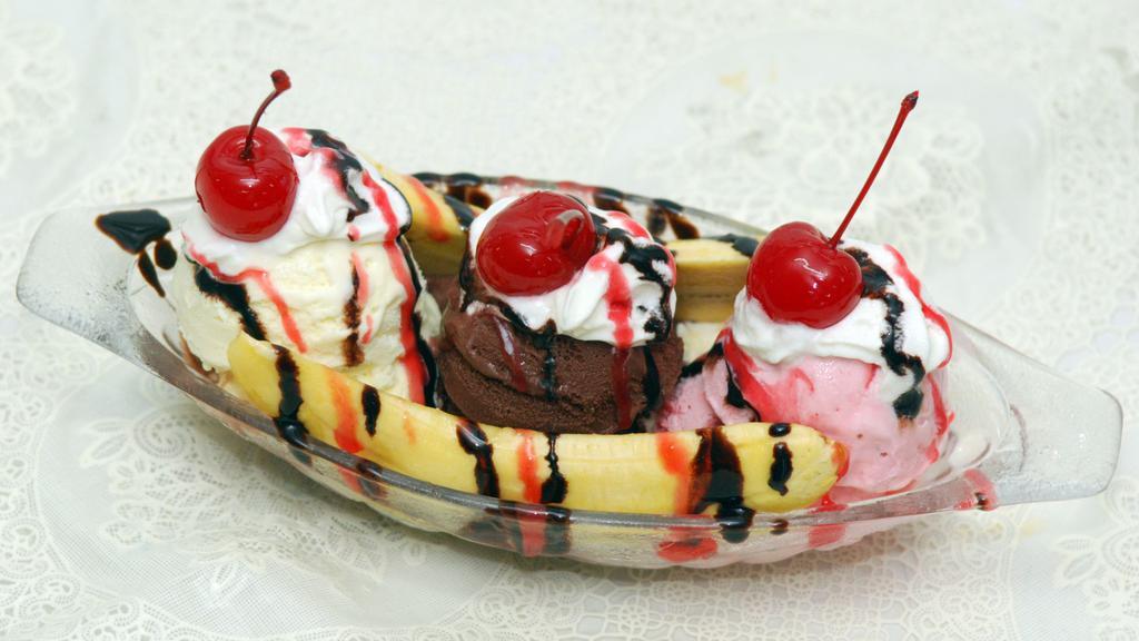 Banana Split · Includes 3 scoops of Ice Cream, a banana, and then topped with hot fudge, strawberry topping, peanuts, rainbow sprinkles, whip cream and cherries