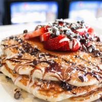 Berry Yours · Choice of chocolate chip waffle or pancakes topped with fresh strawberries, chocolate chips,...
