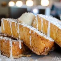 Churro · coated in cinnamon sugar. topped with cream cheese glaze & powdered sugar. drizzled with van...