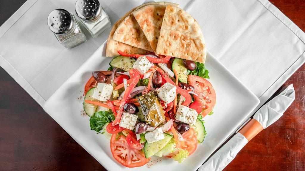 Greek Salad · Romaine lettuce , tomato, cucumber, red onion, pepper, radish, olives, feta cheese and red wine vinaigrette. Served with pita bread.