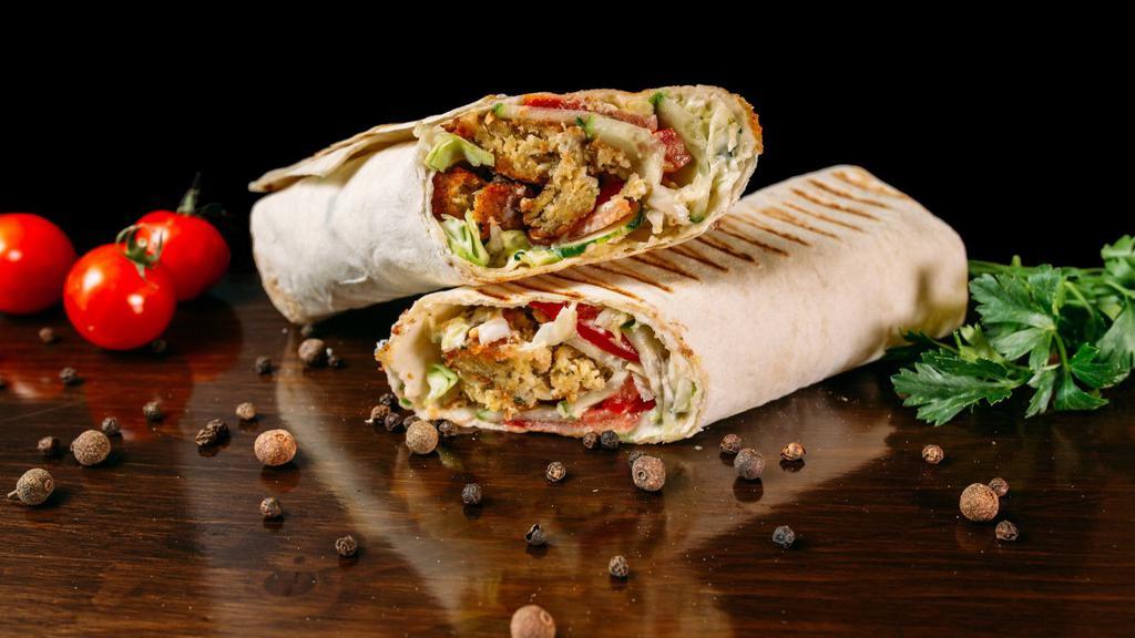 Chicken & Falafel Gyro · Golden fried falafel and perfectly seasoned chicken wrapped in fresh pita, served with lettuce, tomatoes and cucumbers.
