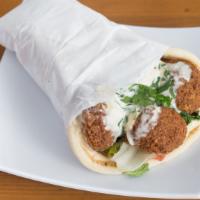 Falafel Gyro · Golden fried falafel wrapped in fresh pita, served with lettuce, tomatoes and cucumbers.