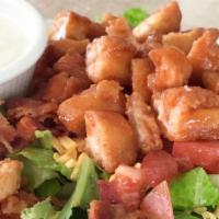 Chicken Buffalo Salad · Fried chicken tenders coated in buffalo sauce, over Romaine lettuce with bacon, tomatoes, & ...