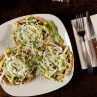 Regular Sopes · Three homemade corn tortillas topped with beans, lettuce, sour cream and cheese.